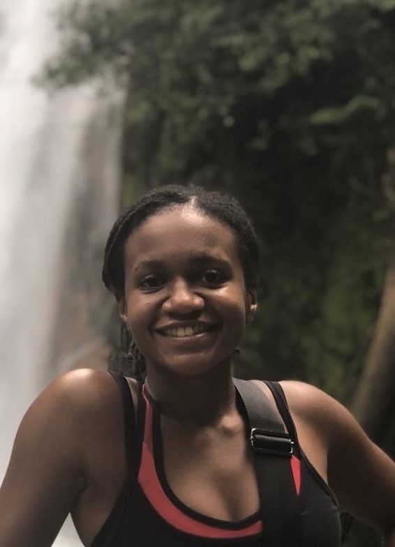 A  portrait photo of Jasmine David in the rainforest